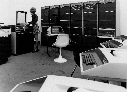 Operator changing disk pack on DEC PDP-11 timesharing system