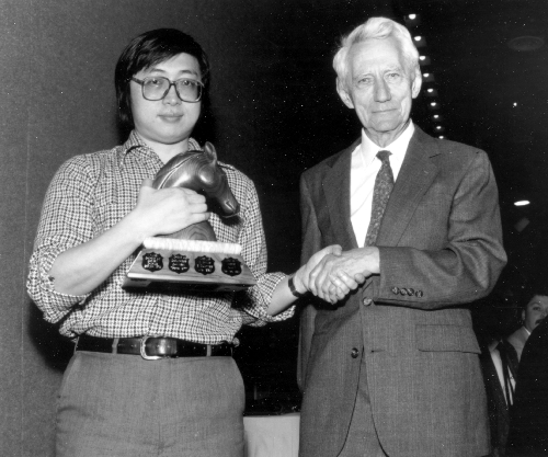 Claude Shannon awards Feng-Hsiung Hsu first prize for Deep Thought at the World Computer Chess Championship in Edmonton, Alberta