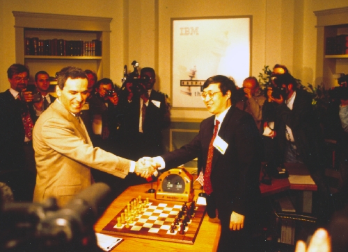 Garry Kasparov shakes hands with Feng-Hsuing Hsu at game 1 of 1997 Deep Blue vs. Kasparov re-match in New York City, New York