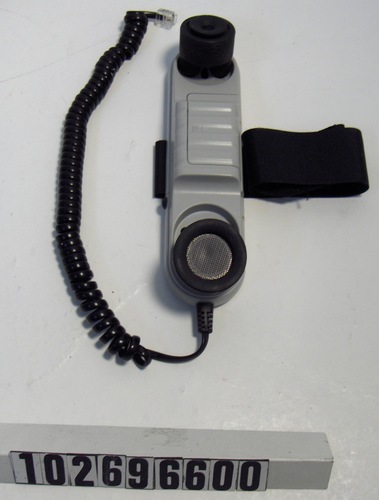 A grey handset with large black rubber earpieces, with a velcro strap